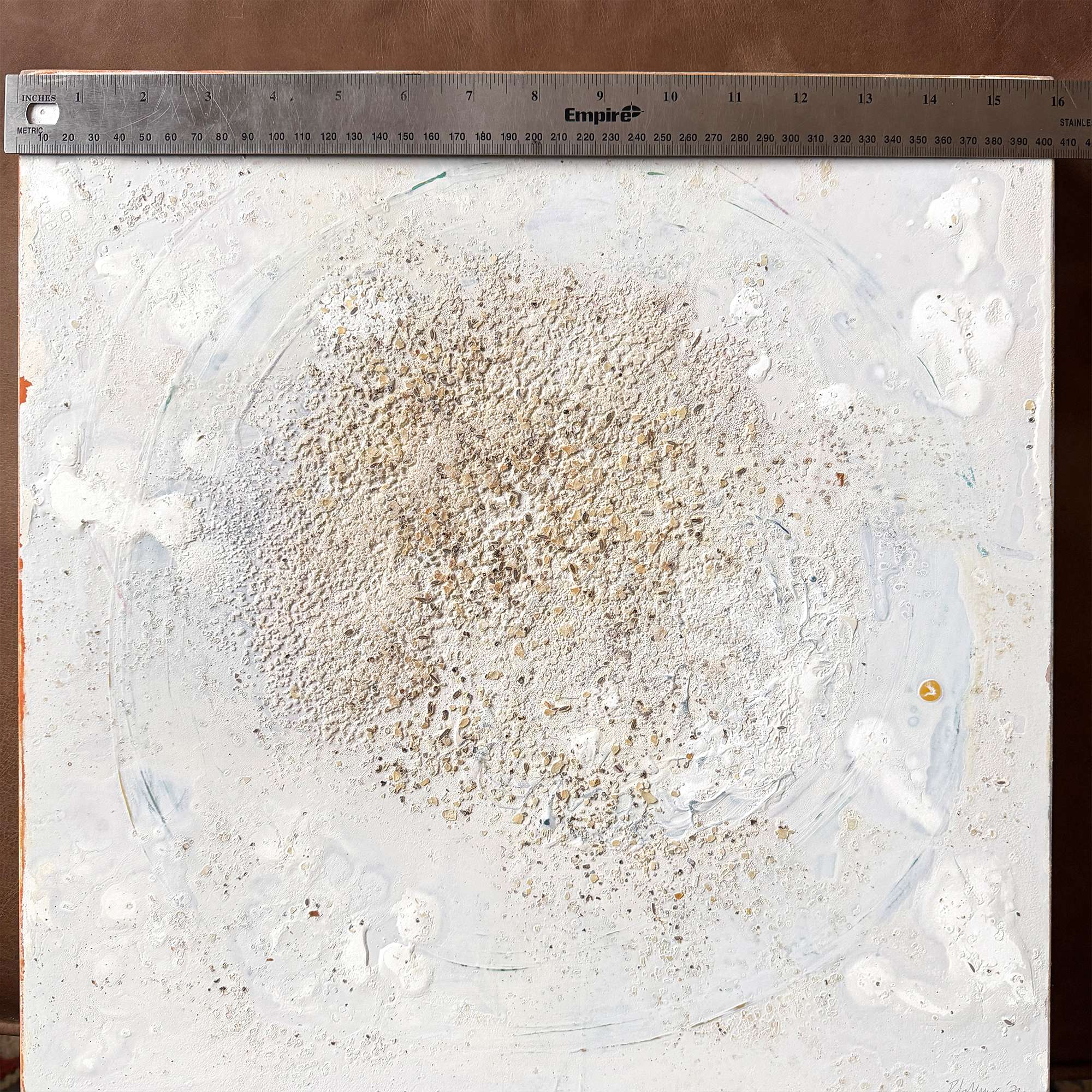"Freckled" is an original 16x16 minimalist abstract painting by Colorado artist Robin Arthur. Created with acrylic and mixed media on gesso board, the piece features subtle textured detail and a neutral palette, bringing a modern, organic feel to contemporary interiors. With 16" ruler.