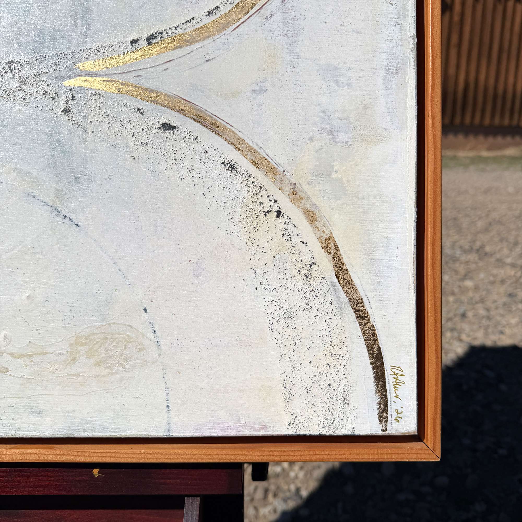 Bottom corner and signature of large original abstract figurative painting 30x40 on gesso board with cedar floater frame in neutral contemporary minimalist style