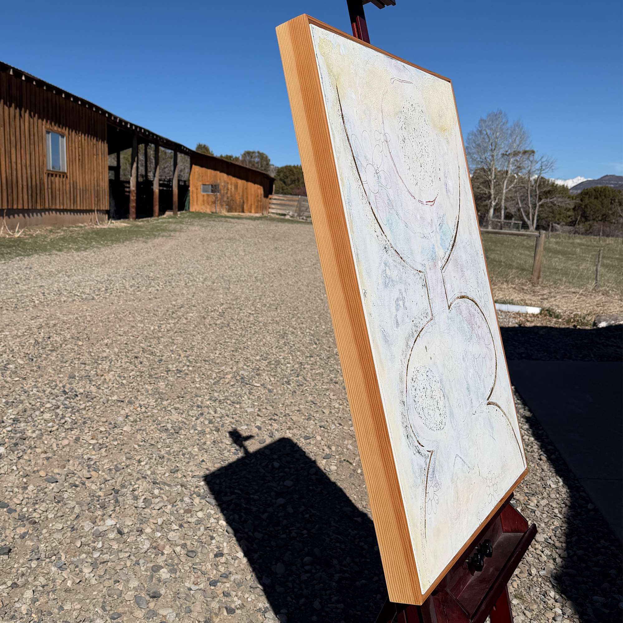 Outdoor photo, barn to left, side of Large original abstract figurative painting 30x40 on gesso board with cedar floater frame in neutral contemporary minimalist style